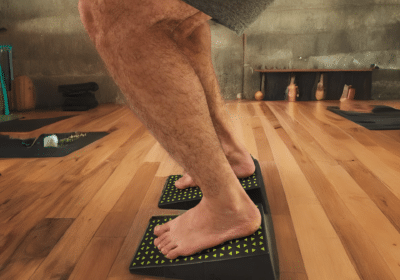 Close-up of barefoot yoga squat using Flexelent squat wedges