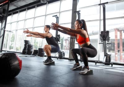 Two people performing versatile workout routines with Flexelent wedges in the gym